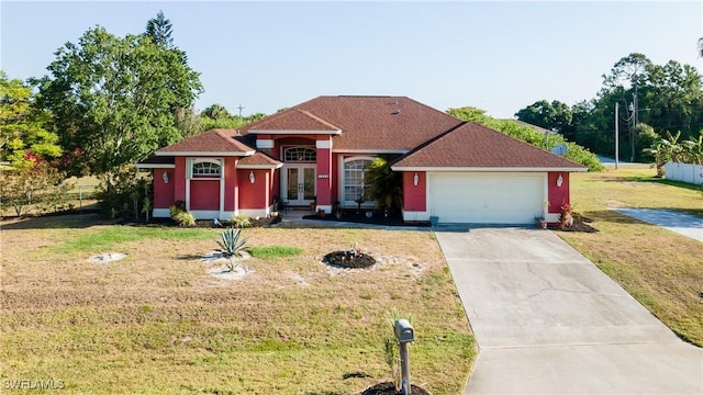 view of front facade featuring concrete driveway, french doors, a front lawn, and a garage
