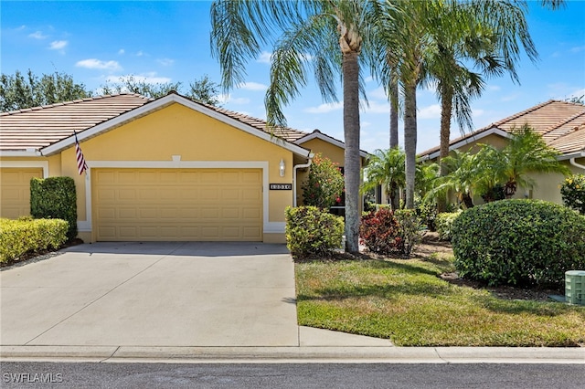 view of front of property featuring concrete driveway, a tiled roof, an attached garage, and stucco siding