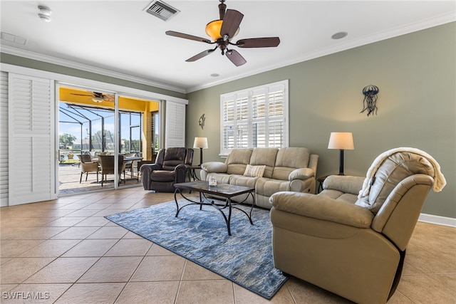 living room featuring ceiling fan, tile patterned floors, baseboards, visible vents, and ornamental molding