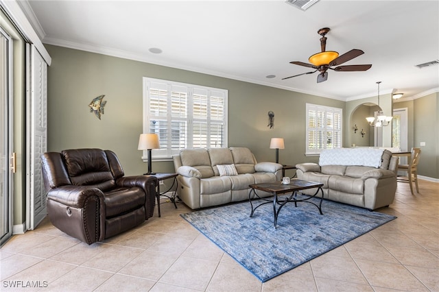living area with crown molding, ceiling fan with notable chandelier, baseboards, light tile patterned floors, and visible vents