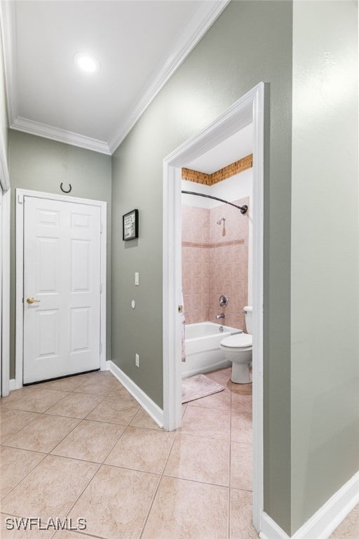 foyer entrance with light tile patterned flooring, baseboards, and ornamental molding