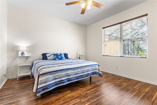bedroom featuring baseboards, a ceiling fan, and wood finished floors