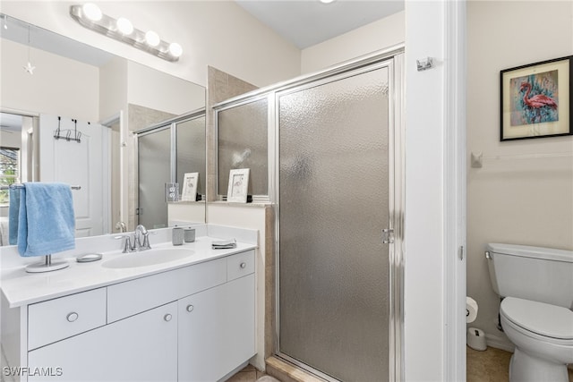 full bathroom featuring toilet, a shower stall, tile patterned flooring, and vanity
