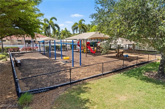 community playground featuring fence and a yard
