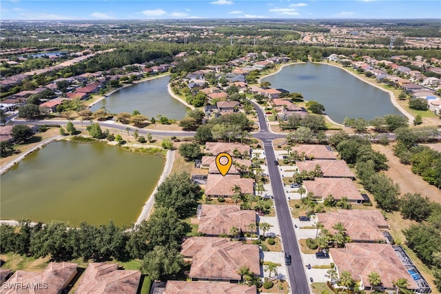 birds eye view of property with a water view and a residential view