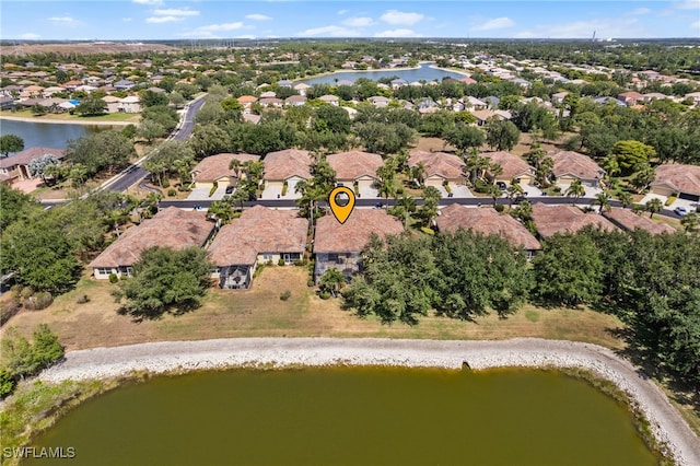 drone / aerial view with a water view and a residential view