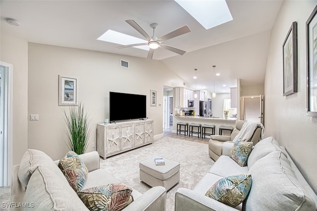 15178 Parkside Dr Unit 204, Fort Myers, FL 33908 - living area with a skylight, lofted ceiling, a ceiling fan, and baseboards