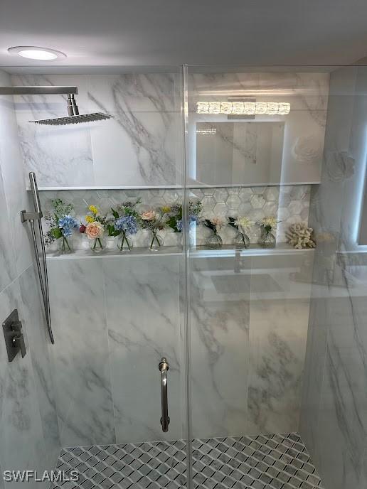 full bathroom with a marble finish shower