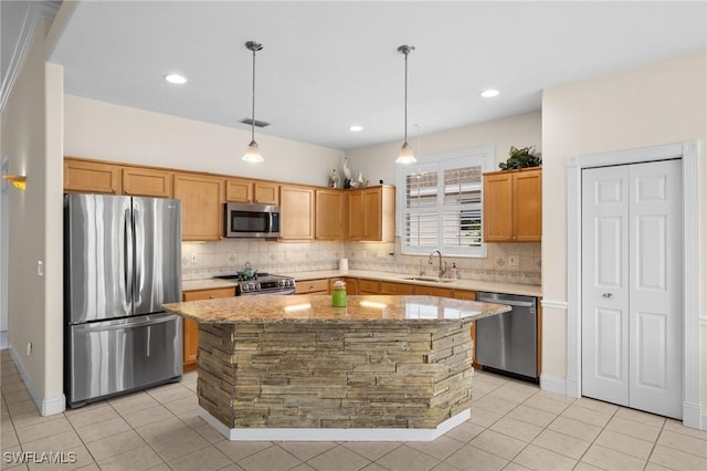 23125 Marsh Landing Blvd, Estero, FL 33928 - kitchen featuring light stone countertops, appliances with stainless steel finishes, a sink, decorative backsplash, and a kitchen island