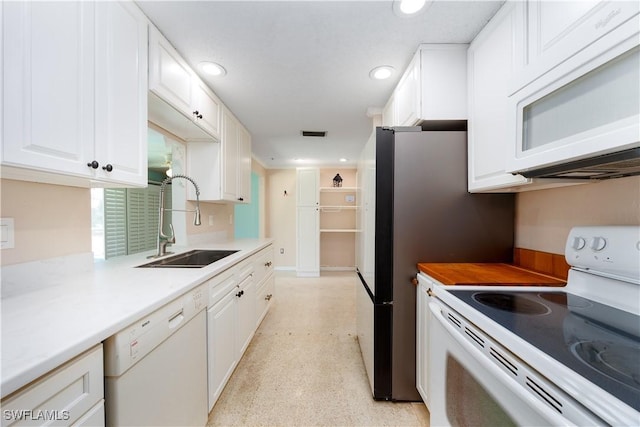 kitchen with visible vents, white appliances, recessed lighting, white cabinets, and a sink