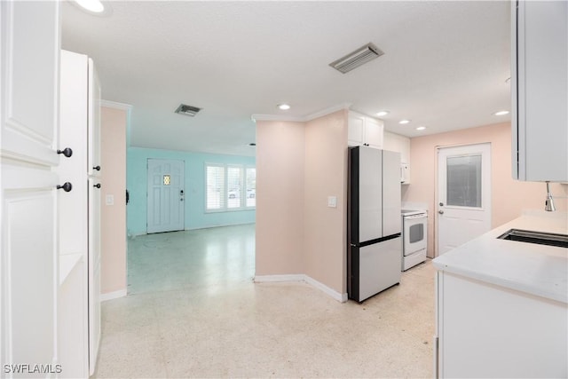 kitchen with white appliances, baseboards, visible vents, and light countertops