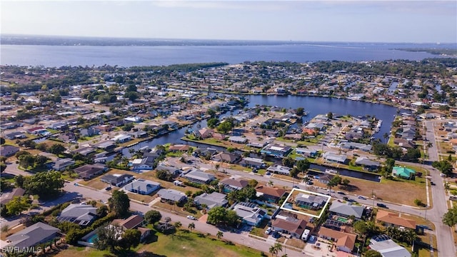 bird's eye view featuring a residential view and a water view