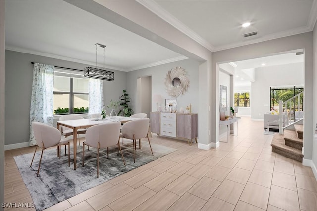 dining room with baseboards, stairs, crown molding, and visible vents