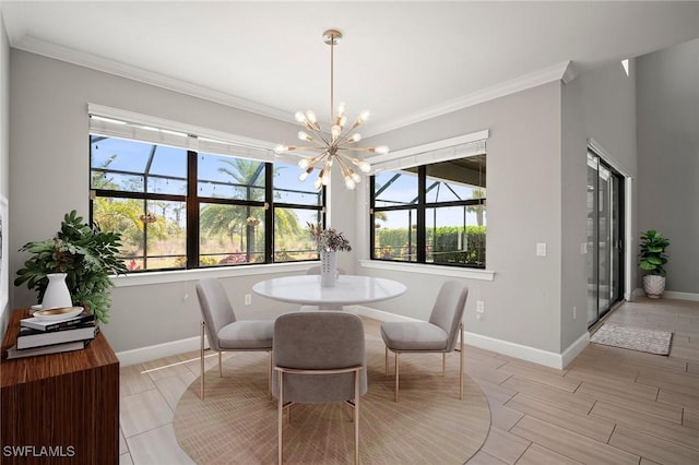 dining room featuring crown molding, baseboards, and a healthy amount of sunlight