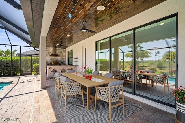 view of patio with outdoor dining area, area for grilling, and an outdoor pool