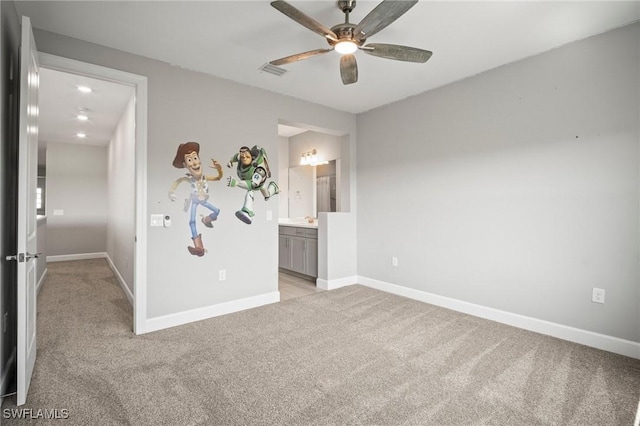 unfurnished bedroom with baseboards, light carpet, and visible vents