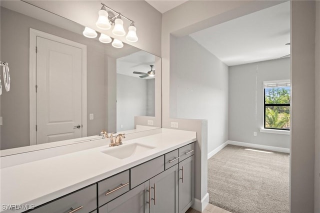bathroom featuring baseboards, ceiling fan, and vanity