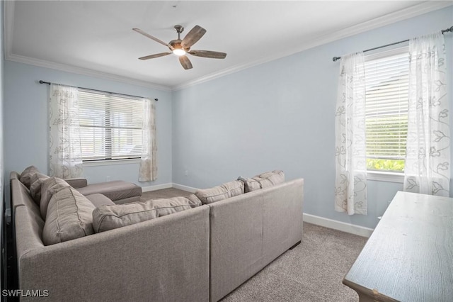 carpeted living room featuring crown molding, baseboards, and ceiling fan