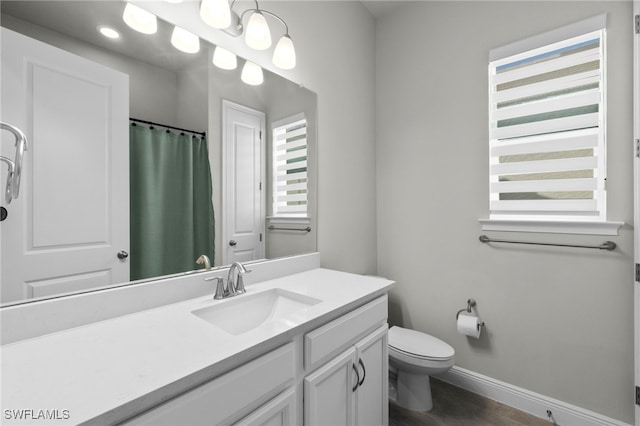 3419 Pilot Cir, Naples, FL 34120 - full bath featuring baseboards, wood finished floors, toilet, and vanity