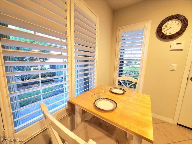 8657 Querce Ct, Naples, FL 34114 - dining area with light tile patterned flooring and baseboards