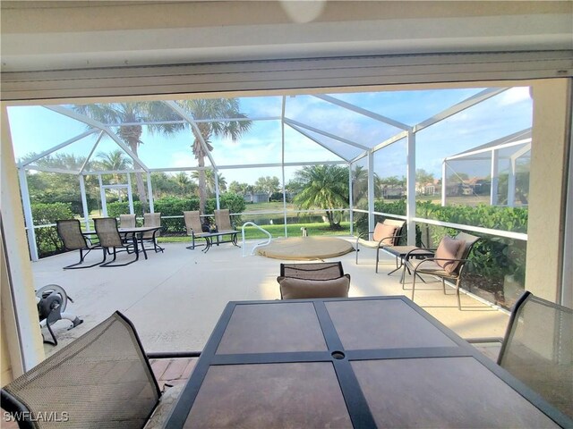 8657 Querce Ct, Naples, FL 34114 - view of patio / terrace with outdoor dining area and a lanai