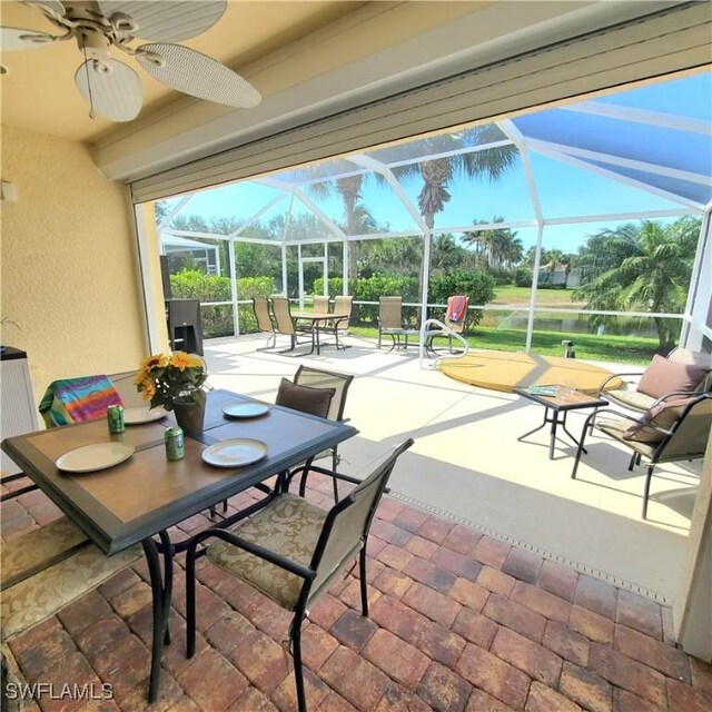 8657 Querce Ct, Naples, FL 34114 - sunroom featuring a ceiling fan, outdoor dining space, and a water view