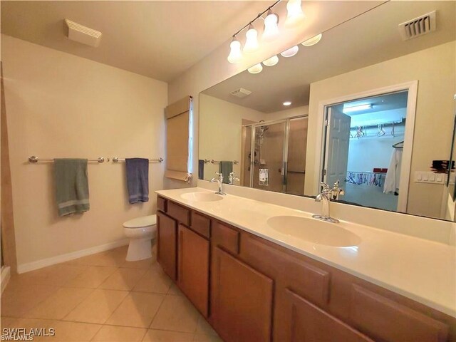 8657 Querce Ct, Naples, FL 34114 - bathroom featuring a stall shower, tile patterned floors, baseboards, toilet, and double vanity