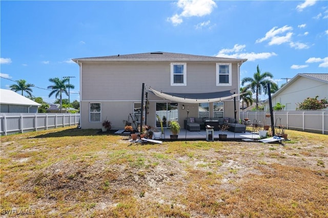 back of house featuring an outdoor hangout area, a yard, a fenced backyard, and a patio area