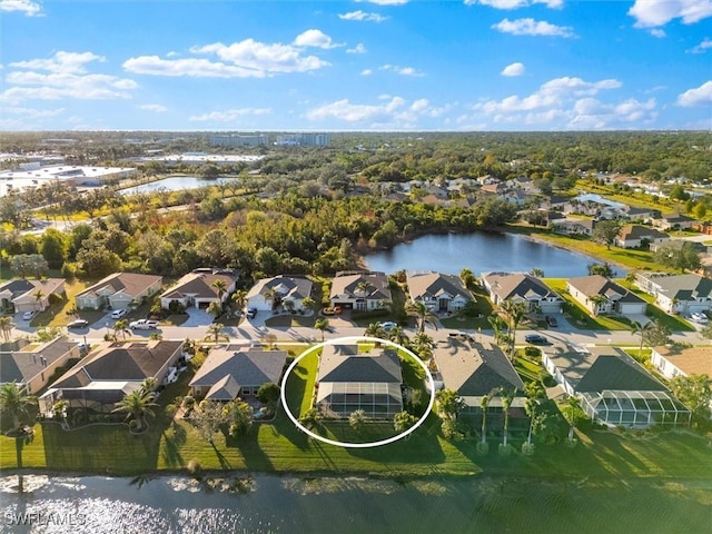 drone / aerial view featuring a residential view and a water view