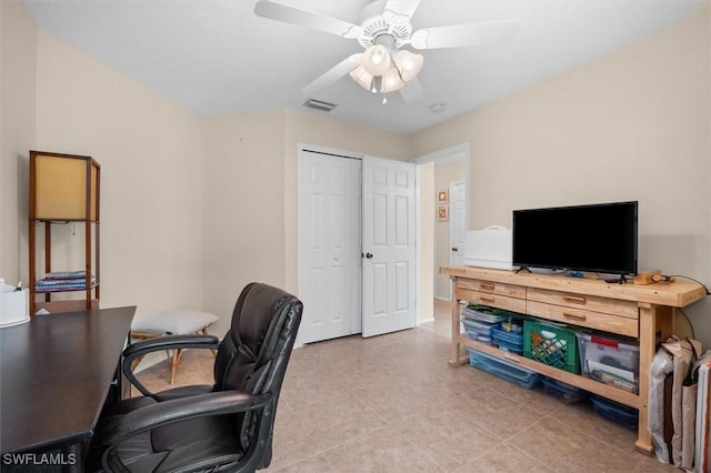 office space featuring visible vents, a ceiling fan, and tile patterned flooring