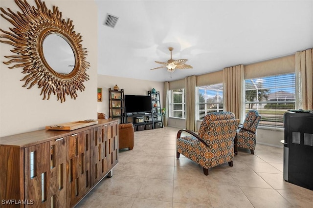living area with visible vents, ceiling fan, and light tile patterned flooring