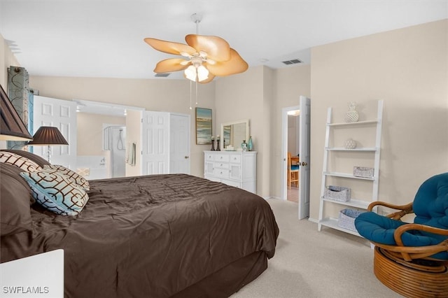 bedroom with connected bathroom, ceiling fan, visible vents, light colored carpet, and lofted ceiling