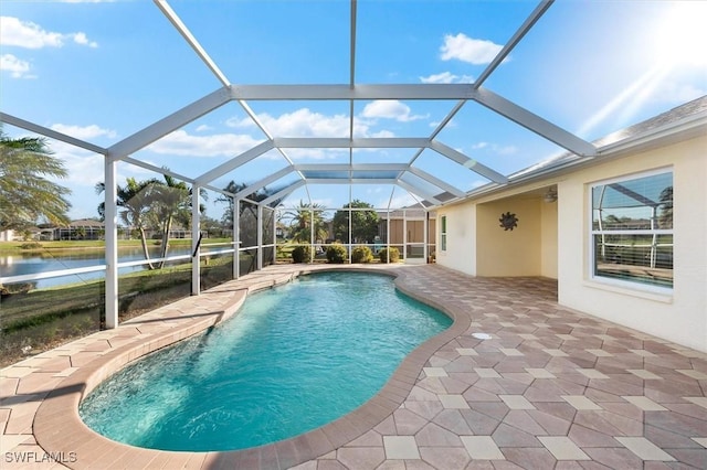 outdoor pool featuring a patio and a water view