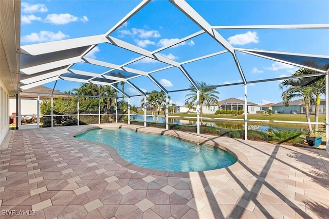 outdoor pool featuring a patio, a lanai, and a water view