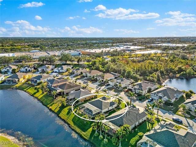 bird's eye view featuring a residential view and a water view