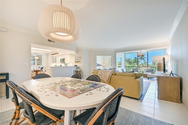 6549 Marissa Loop Unit 26, Naples, FL 34108 - dining room featuring crown molding, a notable chandelier, and a wealth of natural light