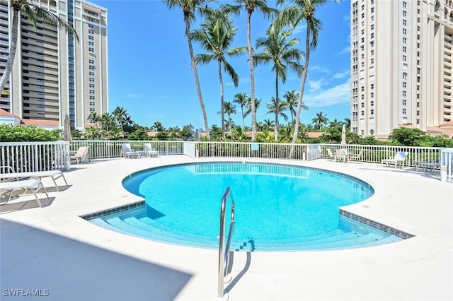 6549 Marissa Loop Unit 26, Naples, FL 34108 - community pool with fence and a patio