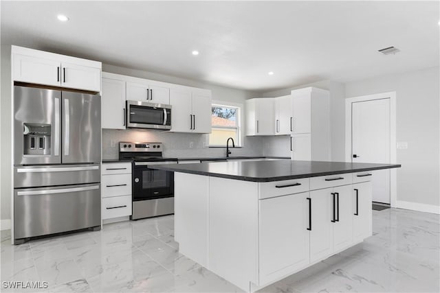 kitchen with dark countertops, visible vents, stainless steel appliances, recessed lighting, and marble finish floor