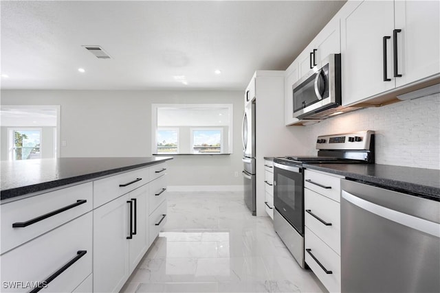 kitchen with stainless steel appliances, marble finish floor, visible vents, backsplash, and dark countertops
