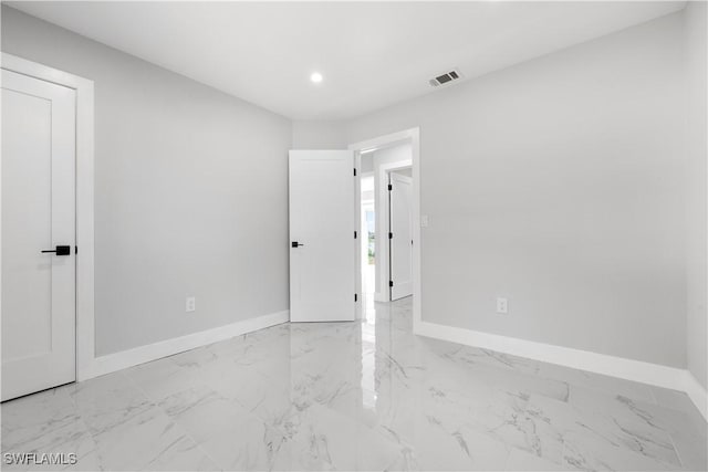 unfurnished bedroom featuring baseboards, visible vents, and marble finish floor