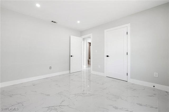 empty room with visible vents, recessed lighting, and baseboards