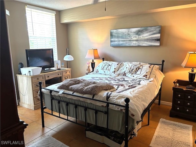 8687 River Homes Ln Unit 4107, Bonita Springs, FL 34135 - bedroom with tile patterned flooring and baseboards