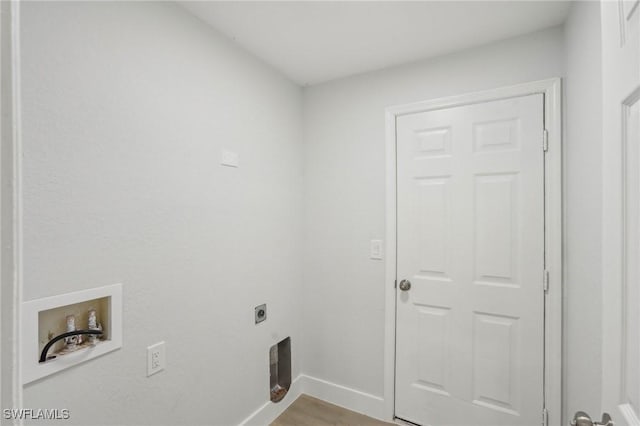 clothes washing area with laundry area, wood finished floors, baseboards, hookup for a washing machine, and electric dryer hookup