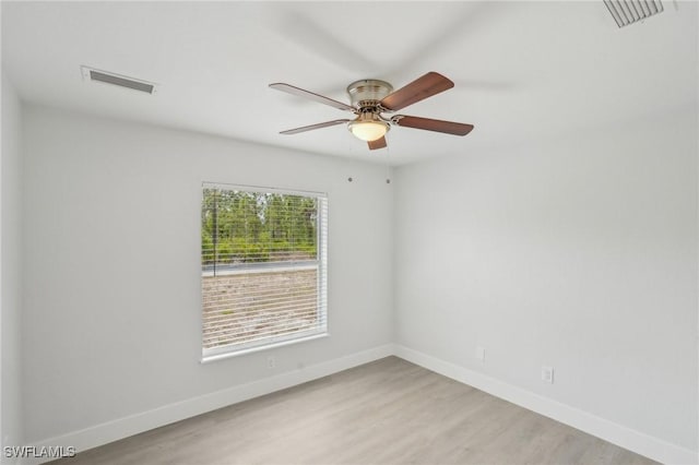 spare room with visible vents, baseboards, and light wood-type flooring