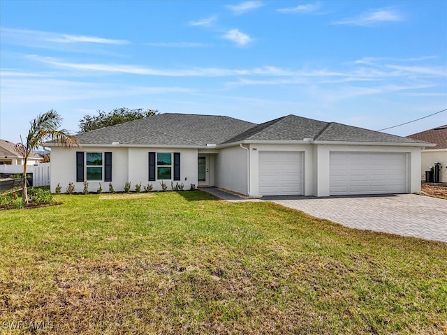 1904 NW 18th St, Cape Coral, FL 33993 - single story home featuring decorative driveway, fence, a front lawn, an attached garage, and stucco siding
