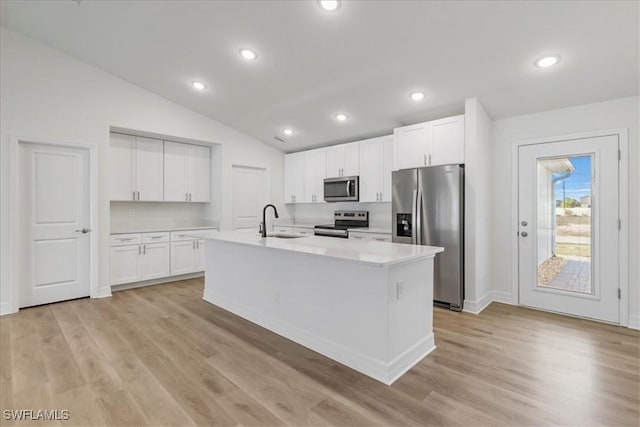 1904 NW 18th St, Cape Coral, FL 33993 - kitchen with a sink, light countertops, lofted ceiling, stainless steel appliances, and white cabinetry