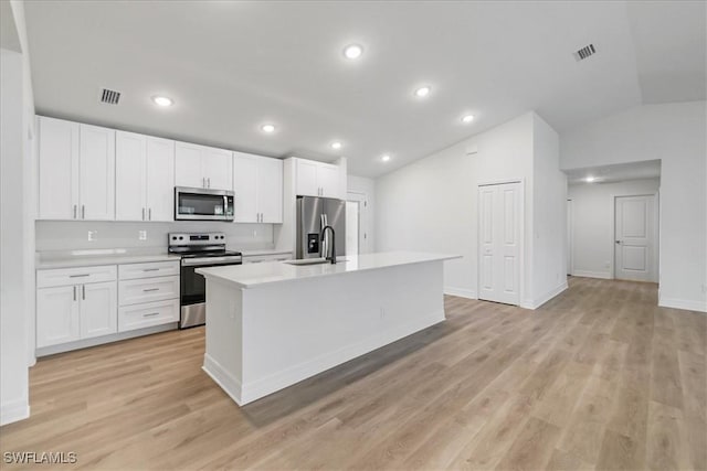 1904 NW 18th St, Cape Coral, FL 33993 - kitchen with light countertops, lofted ceiling, a center island with sink, and stainless steel appliances
