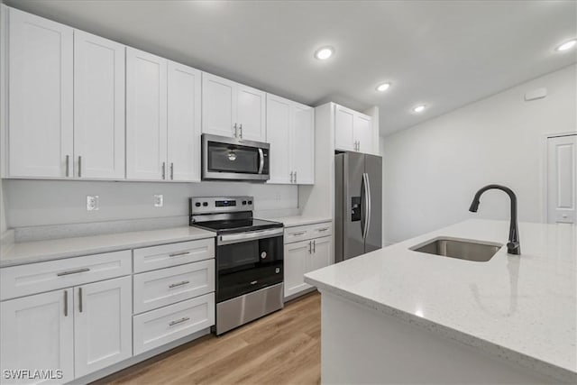 1904 NW 18th St, Cape Coral, FL 33993 - kitchen featuring recessed lighting, a sink, white cabinetry, and appliances with stainless steel finishes