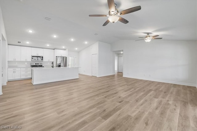 1904 NW 18th St, Cape Coral, FL 33993 - unfurnished living room with ceiling fan, baseboards, light wood finished floors, lofted ceiling, and recessed lighting