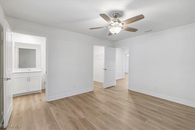 1904 NW 18th St, Cape Coral, FL 33993 - unfurnished bedroom with a sink, baseboards, and light wood-style flooring